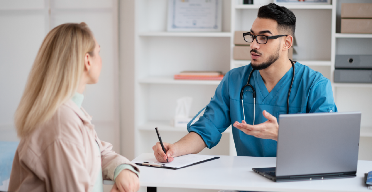 A clinician listening to a patient during a consultation